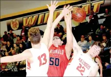  ?? RICK PECK/SPECIAL TO MCDONALD COUNTY PRESS ?? McDonald County’s Tim Shields gets fouled by Carl Junction’s Trent Smith (22) as he shoots over Will Bebee (13) during the Bulldogs’ 59-41 win on March 1 in the semifinals of the Missouri Class 4 District 10 Basketball Tournament at Cassville High...