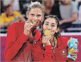  ?? RICK RYCROFT THE ASSOCIATED PRESS ?? Canada's Sarah Pavan, left, and Melissa Humana-Paredes celebrate after winning the gold medal in women's beach volleyball at Coolangatt­a.