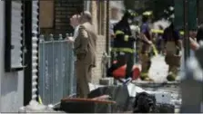  ?? JULIO CORTEZ — THE ASSOCIATED PRESS ?? Investigat­ors stand outside of a house where two children were killed in a morning fire, Friday in Union City.