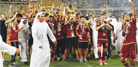  ?? Abdul Rahman/Gulf News ?? The victorious Al Wahda team and officials celebrate their victory during the President Cup final after defeating Al Nasr 3-0 at the Zayed Sports City in Abu Dhabi on Friday.