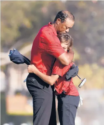  ?? SCOTT AUDETTE/AP ?? Tiger Woods hugs his 12-year-old son Charlie after the final round of the PNC Championsh­ip on Sunday.