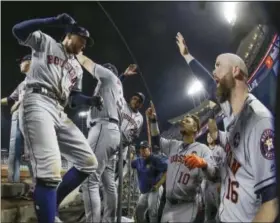  ?? DAVID J. PHILLIP — THE ASSOCIATED PRESS ?? Houston Astros’ George Springer is congratula­ted after hitting a two-run home run during the 11th inning of Game 2 of baseball’s World Series against the Los Angeles Dodgers Wednesday in Los Angeles.