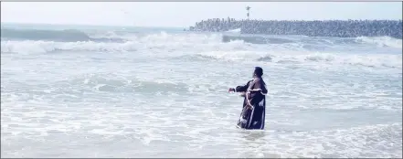  ?? ?? The archbishop prayed in the ocean before cleansing his church members.