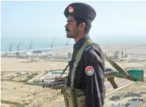  ??  ?? A Pakistani policeman stands guard near the China-funded port of Gwadar, in the Balochista­n province. (AFP)