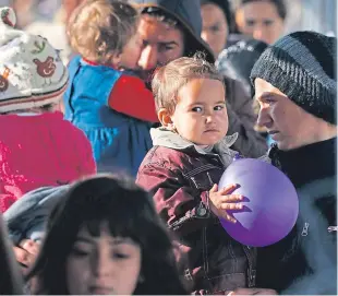  ?? Picture: Associated Press. ?? Migrants wait for food in the makeshift refugee camp at the northern Greek border point of Idomeni, Greece.