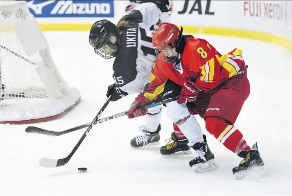  ?? ATSUSHI TOMURA/GETTY IMAGES/FILES ?? Di Deng, right, and China’s national women’s hockey team are hoping to give the country something to cheer for at the 2022 Winter Games in Beijing.