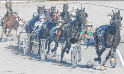  ?? JASON MALLOY/THE GUARDIAN ?? West River Ambyr, with Gilles Barrieau in the bike, leads the pack around the turn during Race 5 Saturday at Red Shores at the Charlottet­own Driving Park.