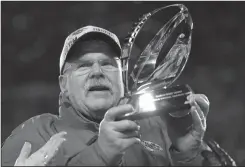  ?? KEVIN C. COX/GETTY IMAGES ?? Head coach Andy Reid of the Kansas City Chiefs holds up the Lamar Hunt Trophy after defeating the Cincinnati Bengals in the AFC Championsh­ip Game on Sunday in Kansas City, Mo.