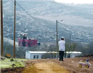  ?? (Nir Elias/Reuters) ?? A RESIDENT walks through the Jewish outpost of Adei Ad.