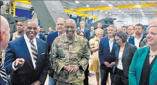  ?? Tara Copp The Associated Press ?? Joint Chiefs Chairman Gen. CQ Brown, center, tours the HIMARS production line Thursday at Lockheed Martin’s Camden, Ark., facility, with Sen. John Bozeman, R-ark., left. The facility manufactur­es rocket launchers which would be part of Ukraine aid.