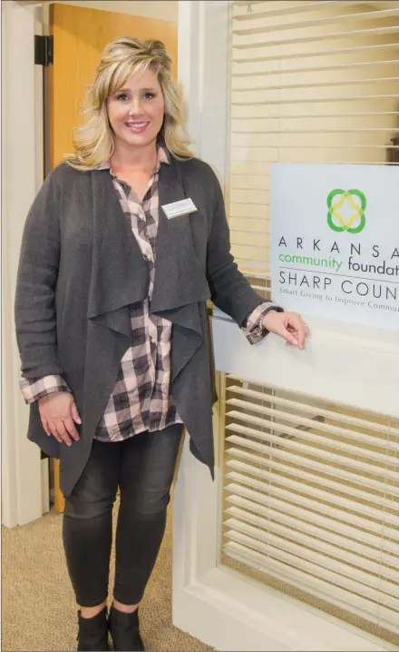  ?? MARK BUFFALO/THREE RIVERS EDITION ?? Stephanie Harris-Dunn, executive director for the Sharp County Community Foundation, stands next to her office inside FNBC in Highland. Harris-Dunn was hired to the position in October 2017. She is a 1992 graduate of Highland High School.