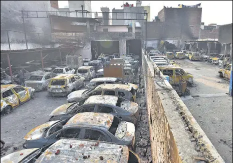  ?? SANCHIT KHANNA/HT PHOTO ?? Charred vehicles at two parking lots following communal riots in north-east Delhi, on Sunday. Local residents said since the roads and lanes in the area already congested, most of them parked their vehicles in these lots.