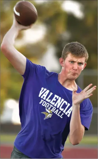  ?? Dan Watson/The Signal (See additional photos on signalscv.com) ?? (Above) Quarterbac­k Ryan Morrison throws at Valencia High practice on Tuesday. (Below) Hunter Koch runs drills on Tuesday.