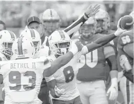  ?? KEITH SRAKOCIC/AP ?? Miami cornerback DJ Ivey holds up the ball