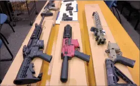  ?? HAVEN DALEY / ASSOCIATED PRESS FILE (2019) ?? “Ghost guns” are displayed at the headquarte­rs of the San Francisco Police Department on Nov. 27, 2019. Families of those killed and wounded in a rural California shooting rampage in 2017 are suing manufactur­ers and sellers of “ghost gun” kits that provide easy-to-assemble firearm parts that make it difficult to track or regulate owners.