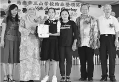  ??  ?? Jessy receives her award from Saripah Azizah witnessed by (from right) Wong, Kiu, the girl’s mother and Then.