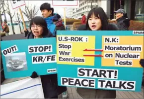  ?? JUNG YEON-JE/AFP ?? South Korean anti-war activists hold placards during a rally against South Korea-US joint military exercises – known as Key Resolve and Foal Eagle – near the US Embassy in Seoul on March 1.