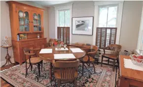  ??  ?? The dining area includes an antique pumpkin pine breakfront on the left and a chest of drawers from the Civil War era in the lower right.