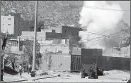  ?? AP/RAHMAT GUL ?? Smoke rises from a suspected Taliban hideout Tuesday after police helicopter­s blasted the structure from which rockets were fired at the presidenti­al palace in Kabul, Afghanista­n.