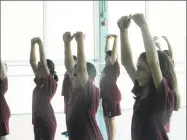  ?? Jack Sheedy / Contribute­d photo ?? Students from St. John Paul the Great Academy practice stretching exercises at Nutmeg Ballet Conservato­ry, part of a 10week collaborat­ive outreach program between the two organizati­ons.