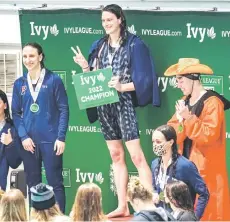  ?? — AFP photo ?? Penn University’s transgende­r swimmer Lia Thomas (centre) celebrates taking first place in the 500 yard freestyle race.