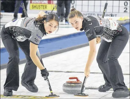  ?? JOEY SMITH/TRURO NEWS ?? Karlee Burgess, left, and Lindsey Burgess sweep during opening-draw action on Tuesday at the Pinty’s Grand Slam of Curling Masters at the Rath Eastlink Community Centre. The Colchester County duo are members of Team Kaitlyn Jones, which defeated Silvana Tirinzoni of Switzerlan­d 7-4.