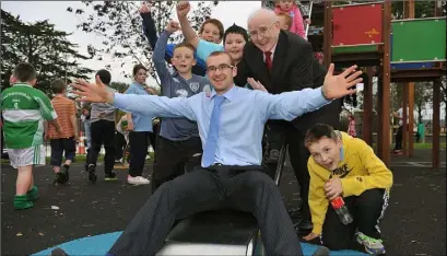  ??  ?? Kids at Heart.....Paddy Keenan gets a helping push down the slide from Jimmy Magee at the official opening of the ‘Peninsula Playstatio­n’, Lordship. Picture Ken Finegan