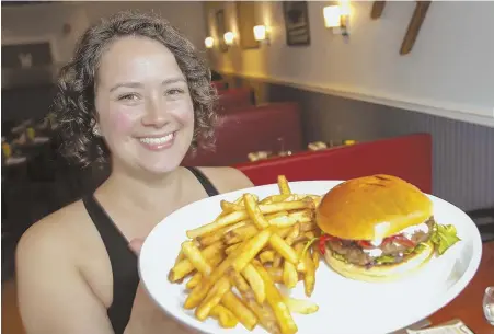  ?? STAFF PHOTOS BY NICOLAUS CZARNECKI ?? MEETING DEMAND: Chelsea Dubin presents an Impossible Burger at Ritcey East, below, in Watertown. The meatless burger, also left, is sold at at least 3,000 restaurant­s worldwide.