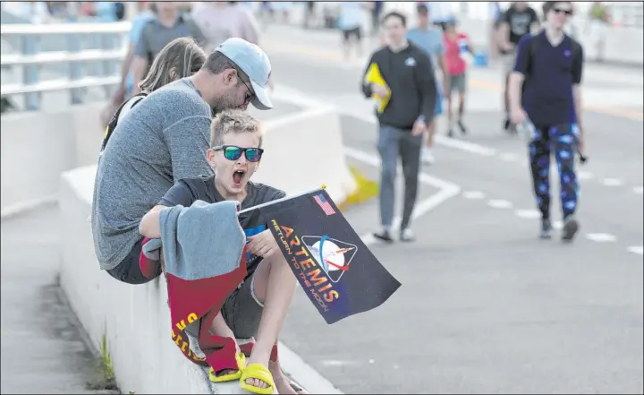  ?? Phelan M. Ebenhack The Associated Press ?? Zeno Rajnai, visiting from Hungary, holds his souvenir flag after the scrub Monday of the launch of the Artemis I moon mission at Kennedy Space Center in Titusville, Fla.