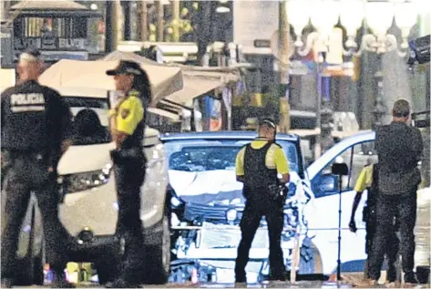  ?? Pictures: Getty/AP. ?? Above: police examine the van used in the terror attack. Right: an injured woman is helped by medics as shocked witnesses are gradually evacuated from the scene.