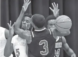  ?? STAFF PHOTO BY ROBIN RUDD ?? East Hamilton’s Sam Randolph (5) collides with Tyner’s Jaylen Bowens (3) after a rebound during the host Hurricanes’ victory Friday night at East Hamilton