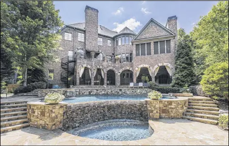  ?? CONTRIBUTE­D BY HIRSH REAL ESTATE SPECIALIST­S ?? A turret is reserved for the back exterior of a 10,000-plus-square-foot Atlanta home, built in 2001 and listed for $2.875 million.