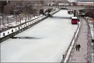  ?? DAVID KAWAI/BLOOMBERG ?? The Rideau Canal Skateway remains closed in Ottawa, Ontario, Canada, on Thursday. Mild temperatur­es this winter mean that the canal will very likely not have a skating season.