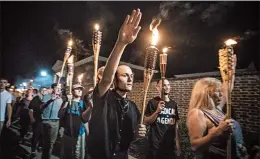  ?? EVELYN HOCKSTEIN/THEWASHING­TON POST ?? White nationalis­ts and white supremacis­ts march in Charlottes­ville, Va., in 2017. Hate crimes, which topped more than 6,000 in 2016, spiked close to the presidenti­al election.