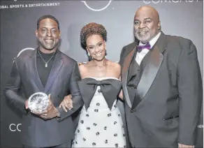  ?? Richard Shotwell
Invision ?? African American Film Critics Associatio­n president Gil Robertson IV, right, poses with celebrity couple Sterling K. Brown and Ryan Michelle Bathe at the AAFCA Awards.