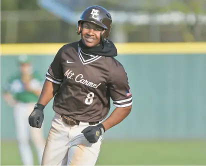  ?? JON CUNNINGHAM/DAILY SOUTHTOWN PHOTOS ?? Mount Carmel’s Brandon Rogers smiles as he rounds the bases after hitting a three-run homer against Providence during a Catholic League Blue game in New Lenox on Monday.