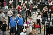  ?? DAVID ZALUBOWSKI — THE ASSOCIATED PRESS ?? Travelers wear face coverings in the line for the south north security checkpoint in the main terminal of Denver Internatio­nal Airport, Aug. 24, in Denver.