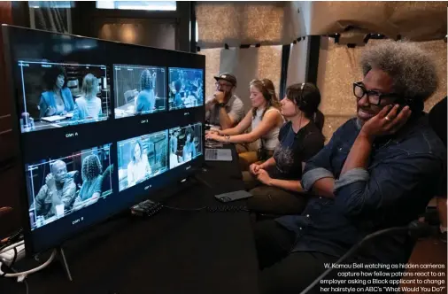  ?? ?? W. Kamau Bell watching as hidden cameras capture how fellow patrons react to an employer asking a Black applicant to change her hairstyle on ABC's “What Would You Do?”