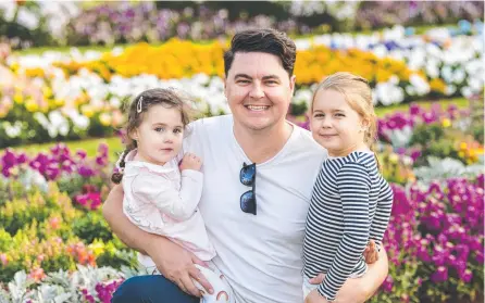  ?? Picture: Kevin Farmer ?? BLOOMING FUN: Kieran McLachlan with daughters Audrey (left) and Evelyn McLachlan were in Queens Park on Saturday. Businesses are hoping a Covid lockdown does not prevent more families from visiting.