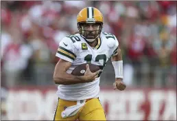  ?? JED JACOBSOHN — THE ASSOCIATED PRESS ?? Green Bay Packers quarterbac­k Aaron Rodgers (12) runs against the San Francisco 49ers in Santa Clara on Sunday.