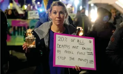  ?? Photograph: Andrew Milligan/PA ?? Protesters stage a candle-lit demonstrat­ion at the Cop26 summit.