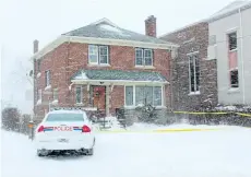  ?? ALLAN BENNER/POSTMEDIA NETWORK ?? A Niagara Regional Police cruiser is parked at a Lake Street home in St. Catharines wrapped in yellow police caution tape Tuesday morning. A woman was shot during a home invasion Monday evening.