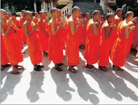  ??  ?? ANCIENT PRACTICE: Buddhist monks pray at a pagoda in Phnom Penh, Cambodia, celebratin­g after the Sambor Prei Kuk archaeolog­ical site was added to Unesco’s World Heritage list.