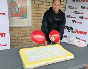  ??  ?? CAKE FOR KENTON: TotT sales rep Mitch Haupt manned the table handing out cake for TotT’s 20th birthday outside Sunshine Spar in Kenton last year