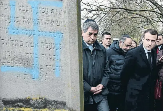  ?? FREDERICK FLORIN / AFP ?? El presidente Macron visitó ayer el cementerio judío de Quatzenhei­m, en Alsacia, horas después de ser profanado con esvásticas