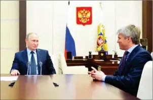  ?? ALEXEI DRUZHININ/SPUTNIK/AFP ?? Russian President Vladimir Putin (left) speaks with Deputy Sports Minister Pavel Kolobkov on October 19. Putin has referred to doping in sport as an ‘evil’.