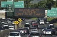  ?? ANTHONY QUINTANO/CIVIL BEAT VIA THE ASSOCIATED PRESS ?? Cars on a highway in Hawaii drive past a sign announcing the missile alert in Honolulu has been cancelled.