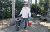  ?? CARLINE JEAN/SUN SENTINEL ?? Steven Garcia, with Broward County mosquito control, removes a mosquito trap in Fort Lauderdale on Tuesday.