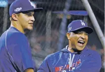  ?? AP FILE PHOTO ?? Los Angeles Dodgers manager Dave Roberts, right, jokes Oct. 13 with shortstop Corey Seager during batting practice before Game 5 of the National League Division Series against the Washington Nationals. The Dodgers earned a four-day break before the...