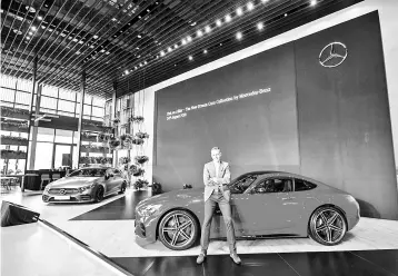  ??  ?? Raine poses with the Mercedes-AMG GT (right) and Mercedes-AMG CLS 53 (left).